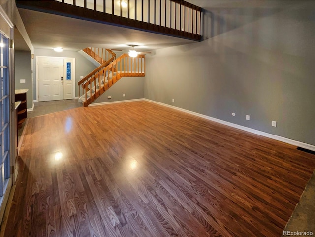 unfurnished living room featuring hardwood / wood-style flooring and ceiling fan