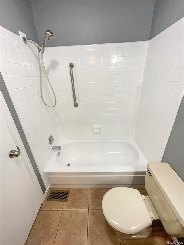 bathroom featuring bathtub / shower combination, tile patterned floors, and toilet