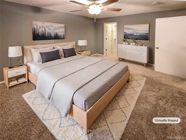 bedroom with ceiling fan, carpet, and a textured ceiling