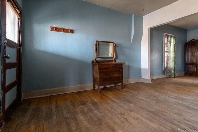 unfurnished room featuring hardwood / wood-style floors and plenty of natural light