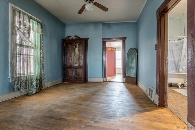 unfurnished room with hardwood / wood-style flooring and ceiling fan