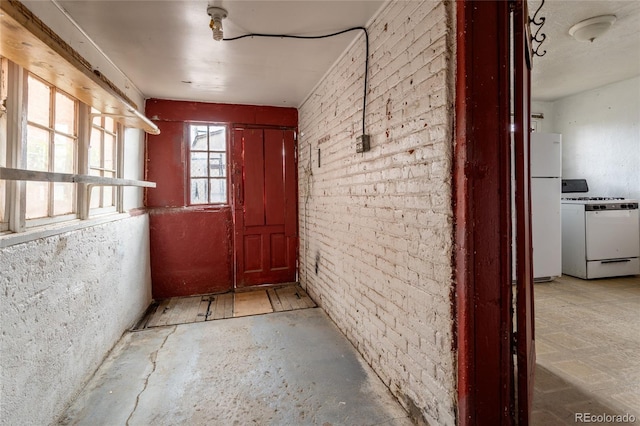 hallway featuring brick wall