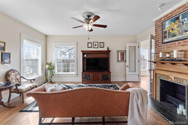 7996 Bradburn Blvd, Westminster, CO 80030 - living room featuring wood finished floors, ceiling fan, baseboards, and a fireplace