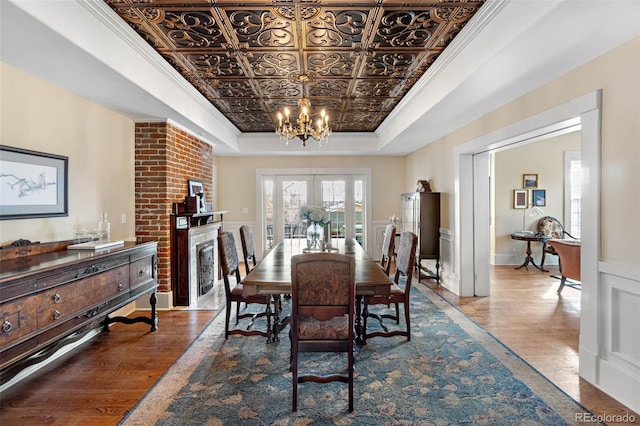 7996 Bradburn Blvd, Westminster, CO 80030 - dining area featuring a raised ceiling, a chandelier, wood finished floors, french doors, and an ornate ceiling