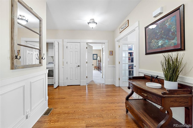 7996 Bradburn Blvd, Westminster, CO 80030 - entryway featuring light wood-type flooring and washer / dryer