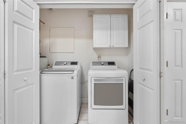 7996 Bradburn Blvd, Westminster, CO 80030 - laundry area featuring cabinet space, independent washer and dryer, and light tile patterned floors