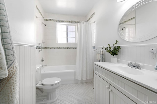 7996 Bradburn Blvd, Westminster, CO 80030 - bathroom with a wainscoted wall, toilet, vanity, shower / bathtub combination with curtain, and tile patterned flooring