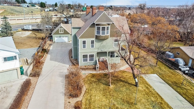 7996 Bradburn Blvd, Westminster, CO 80030 - view of front of home featuring driveway, roof with shingles, and a chimney