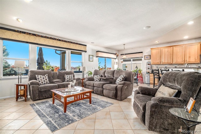 living room featuring a textured ceiling and light tile patterned floors