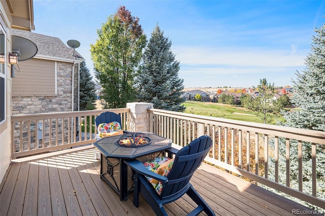 wooden terrace with an outdoor fire pit