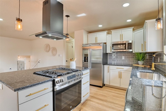 kitchen with light wood-style flooring, a sink, stainless steel appliances, backsplash, and island range hood