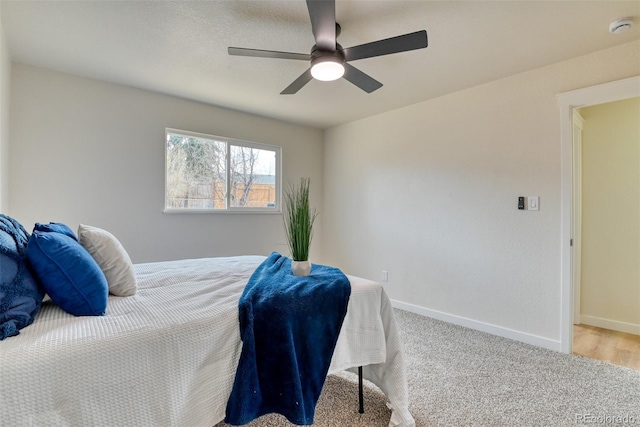 carpeted bedroom with baseboards and ceiling fan