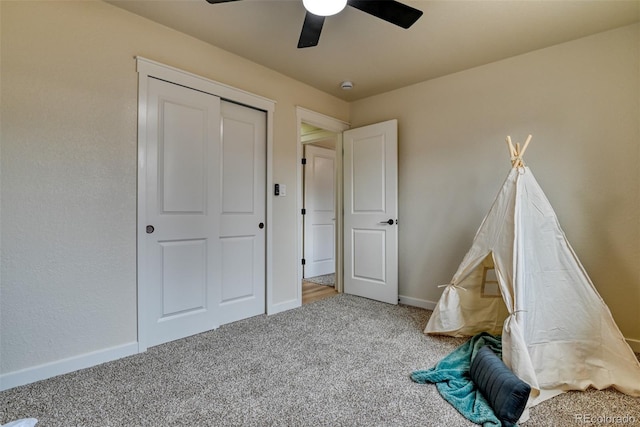 rec room featuring a ceiling fan, baseboards, and carpet floors