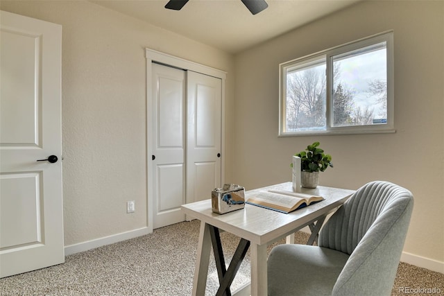 home office featuring light carpet, ceiling fan, and baseboards