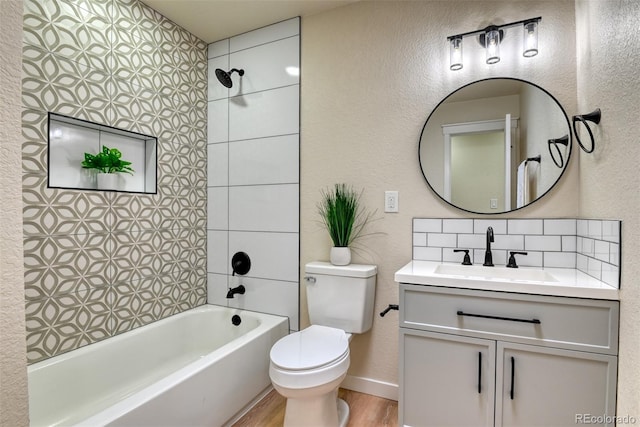 full bath featuring backsplash, shower / washtub combination, toilet, wood finished floors, and vanity