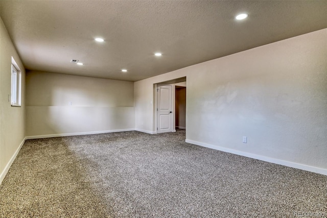 spare room with carpet flooring, recessed lighting, baseboards, and a textured ceiling