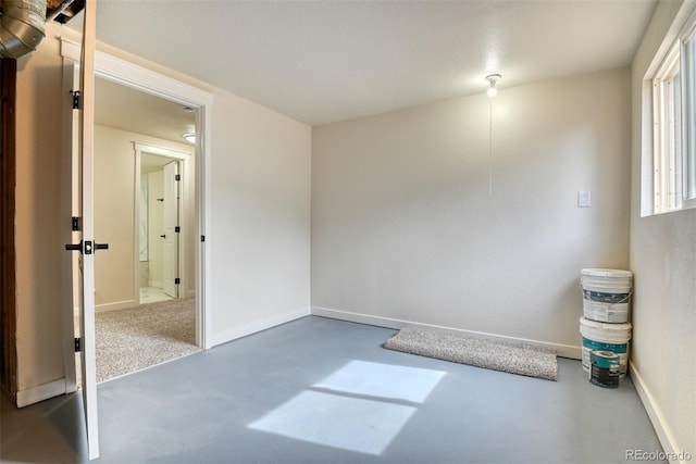 interior space featuring baseboards and finished concrete floors