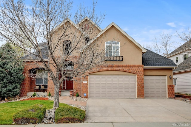 17613 E Peakview Ave, Aurora, CO 80016 - traditional-style house featuring an attached garage, brick siding, driveway, stucco siding, and a shingled roof