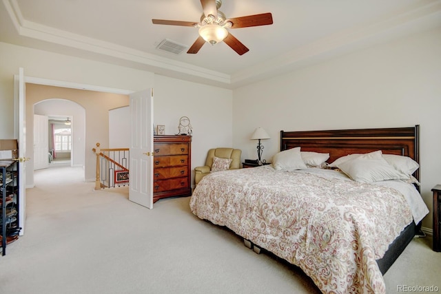 17613 E Peakview Ave, Aurora, CO 80016 - carpeted bedroom with a tray ceiling, crown molding, visible vents, ceiling fan, and arched walkways