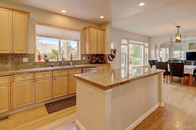 17613 E Peakview Ave, Aurora, CO 80016 - kitchen with a sink, dishwasher, light wood finished floors, open floor plan, and light brown cabinets