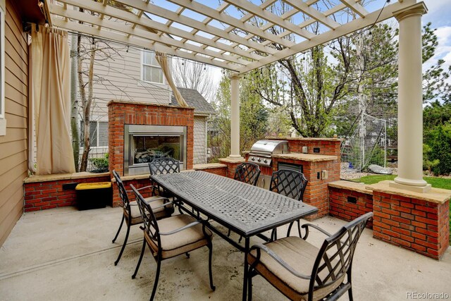 17613 E Peakview Ave, Aurora, CO 80016 - view of patio / terrace with area for grilling, exterior kitchen, a pergola, outdoor dining area, and an outdoor brick fireplace