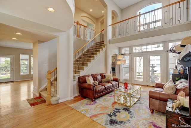 17613 E Peakview Ave, Aurora, CO 80016 - living room featuring a towering ceiling, stairway, wood finished floors, and baseboards