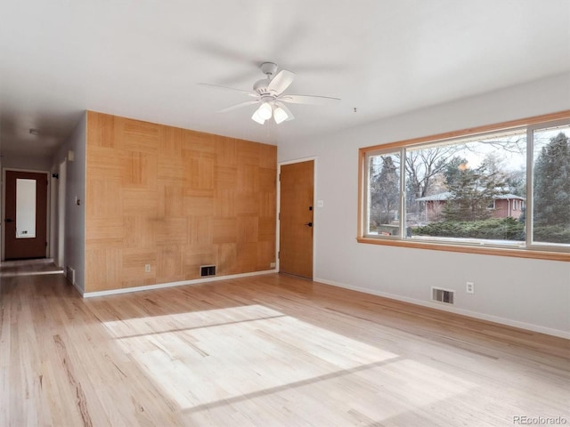 empty room with light wood-type flooring and ceiling fan