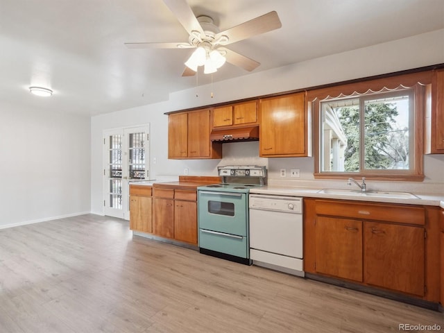 kitchen featuring dishwasher, french doors, sink, light hardwood / wood-style flooring, and electric range