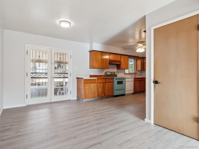 kitchen featuring white dishwasher, ceiling fan, light wood-type flooring, and stainless steel range with electric cooktop