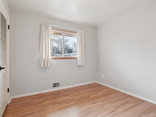 spare room featuring light wood-type flooring