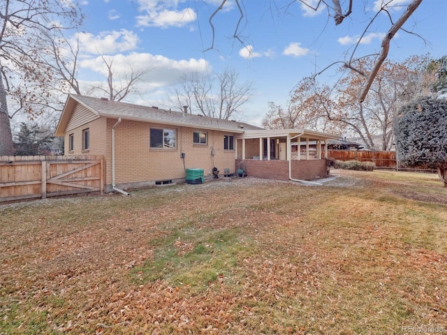 rear view of property with a yard