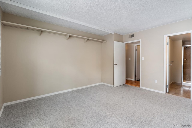 4400 S Quebec St Unit 108L, Denver, CO 80237 - unfurnished bedroom featuring carpet flooring, a textured ceiling, and baseboards