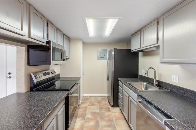 4400 S Quebec St Unit 108L, Denver, CO 80237 - kitchen with stainless steel appliances, a sink, dark countertops, and baseboards