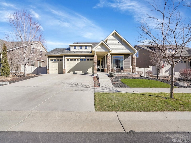 view of front of house featuring a garage, a front yard, and covered porch