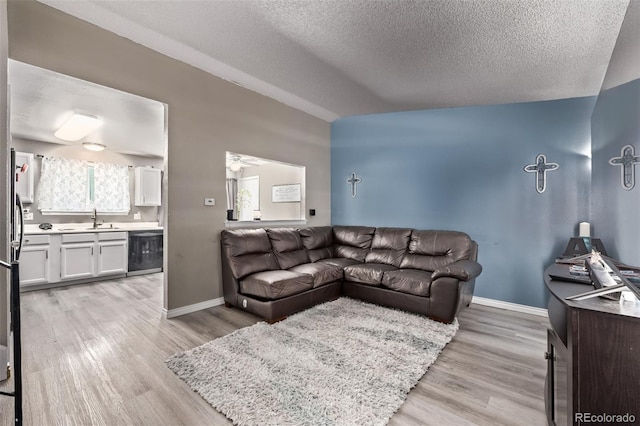 4416 E 93rd Pl, Thornton, CO 80229 - living room with light wood-style floors and a textured ceiling