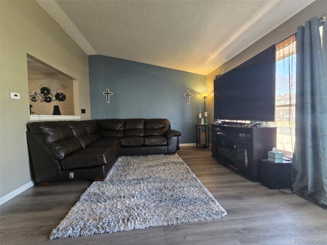 4416 E 93rd Pl, Thornton, CO 80229 - living area with lofted ceiling, a textured ceiling, and wood finished floors
