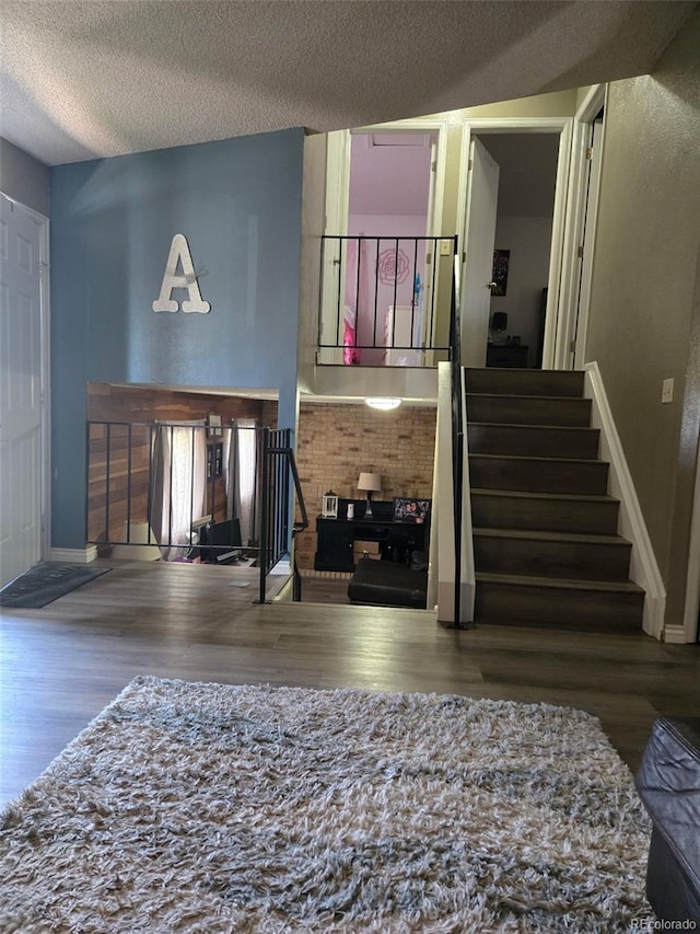 4416 E 93rd Pl, Thornton, CO 80229 - living area featuring wood finished floors, stairs, and a textured ceiling