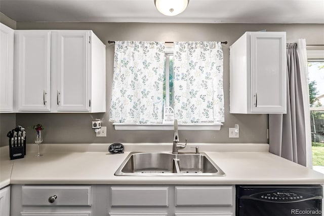 4416 E 93rd Pl, Thornton, CO 80229 - kitchen with black dishwasher, light countertops, and white cabinets