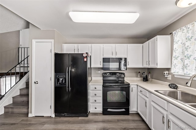 4416 E 93rd Pl, Thornton, CO 80229 - kitchen with black appliances, white cabinets, light countertops, and dark wood-style flooring