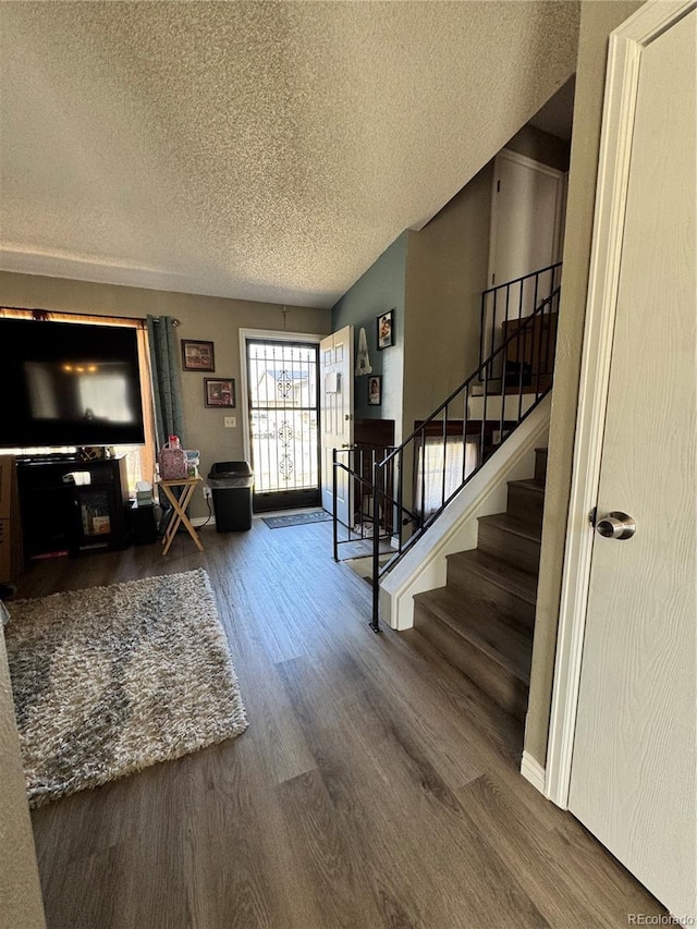 4416 E 93rd Pl, Thornton, CO 80229 - entryway featuring a textured ceiling, wood finished floors, and stairs