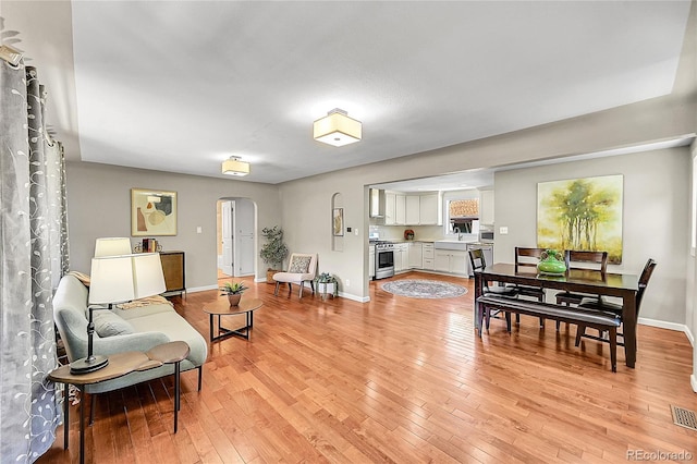 4268 S Delaware St, Englewood, CO 80110 - living area featuring arched walkways and light wood-type flooring