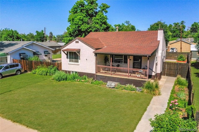 4268 S Delaware St, Englewood, CO 80110 - view of front of property with a porch, a chimney, brick siding, and a shingled roof