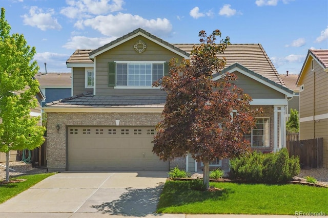 7342 S Mobile St, Aurora, CO 80016 - view of front of property featuring driveway, a garage, a tiled roof, and brick siding