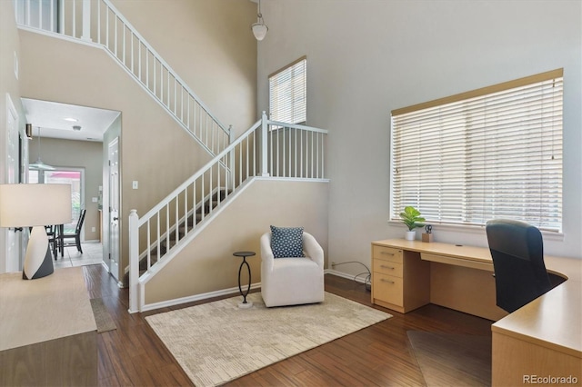 7342 S Mobile St, Aurora, CO 80016 - office space with wood finished floors, a towering ceiling, and baseboards