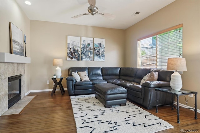 7342 S Mobile St, Aurora, CO 80016 - living room with a ceiling fan, baseboards, wood finished floors, a tiled fireplace, and recessed lighting