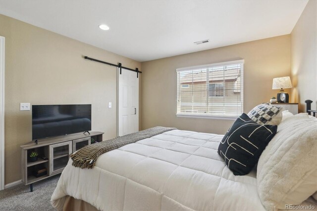 7342 S Mobile St, Aurora, CO 80016 - bedroom with a barn door, carpet flooring, and recessed lighting