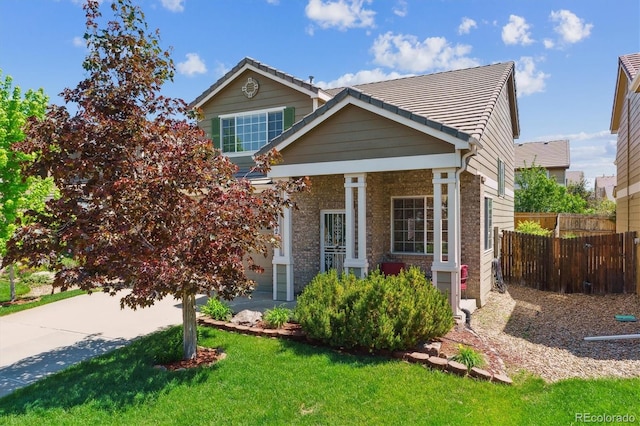 7342 S Mobile St, Aurora, CO 80016 - view of front of property featuring a tiled roof, a porch, and brick siding