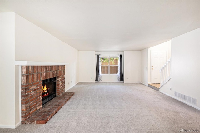 1756 S Quintero Way, Aurora, CO 80017 - unfurnished living room with a fireplace, carpet floors, and stairway
