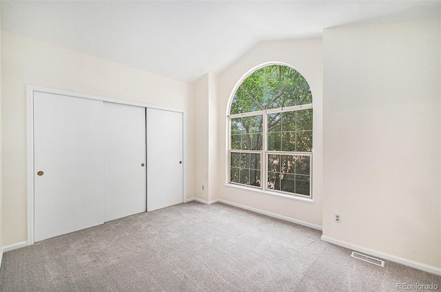 1756 S Quintero Way, Aurora, CO 80017 - unfurnished bedroom with carpet, lofted ceiling, and a closet