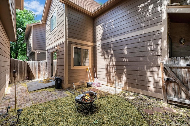 1756 S Quintero Way, Aurora, CO 80017 - view of side of home with a fire pit, a patio area, and roof with shingles